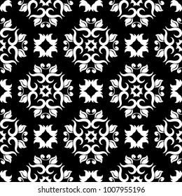 White floral ornament on black background. Seamless pattern for textile and wallpapers