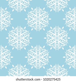 White floral ornament on blue background. Seamless pattern for textile and wallpapers