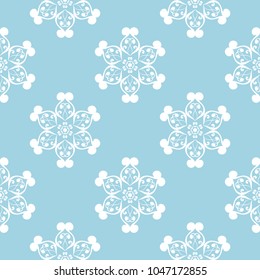 White floral ornament on blue background. Seamless pattern for textile and wallpapers