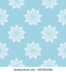 White floral ornament on blue background. Seamless pattern for textile and wallpapers
