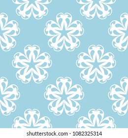 White floral ornament on blue background. Seamless pattern for textile and wallpapers