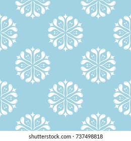 White floral ornament on blue background. Seamless pattern for textile and wallpapers