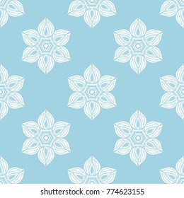 White floral ornament on blue background. Seamless pattern for textile and wallpapers
