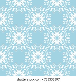 White floral ornament on blue background. Seamless pattern for textile and wallpapers