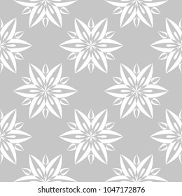 White floral ornament on gray background. Seamless pattern for textile and wallpapers