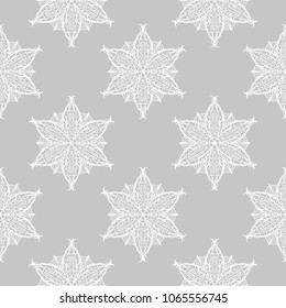 White floral ornament on gray background. Seamless pattern for textile and wallpapers