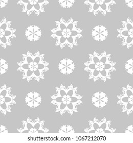 White floral ornament on gray background. Seamless pattern for textile and wallpapers