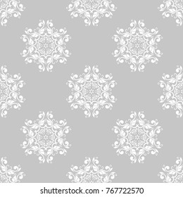 White floral ornament on gray background. Seamless pattern for textile and wallpapers