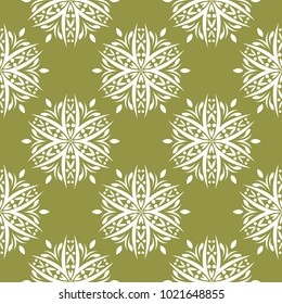 White floral ornament on olive green background. Seamless pattern for textile and wallpapers