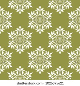 White floral ornament on olive green background. Seamless pattern for textile and wallpapers