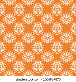 White floral ornament on orange background. Seamless pattern for textile and wallpapers