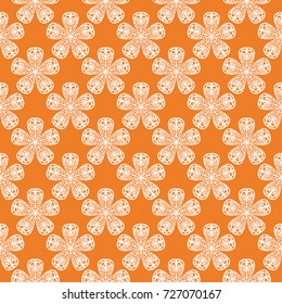 White floral ornament on orange background. Seamless pattern for textile and wallpapers