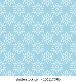 White floral pattern on blue background. Seamless ornament for textile and wallpapers