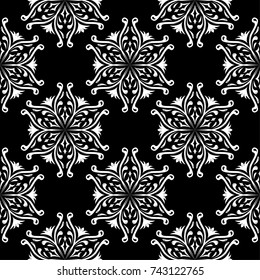 White flowers on black background. Ornamental seamless pattern for textile and wallpapers