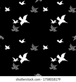 White flying birds silhouette black background in chaotic mess