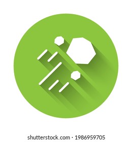 White Flying stone icon isolated with long shadow. Green circle button. Vector