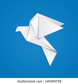 White folded paper, origami pigeon on blue background.