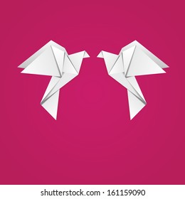 White folded paper, origami pigeon on pink background.