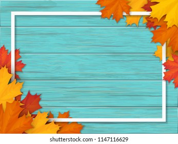 White frame decorated of fallen maple leaves. Autumn foliage on the background of a wooden vintage table surface. Realistic vector illustration.