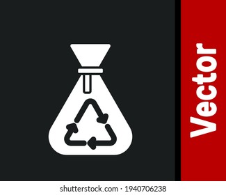 White Garbage bag with recycle symbol icon isolated on black background. Trash can icon. Recycle basket sign.  Vector