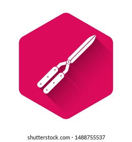 White Gardening handmade scissors for trimming icon isolated with long shadow. Pruning shears with wooden handles. Pink hexagon button. Vector Illustration
