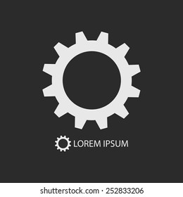White gearwheel as logo with copyspace on dark grey background