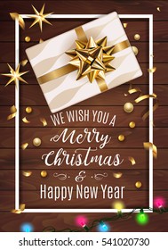 White gift box with a beautiful gold bow on wooden background. Merry Christmas and Happy New Year greeting card. Vintage Background With Typography and Decoration Elements card Vector, eps 10