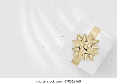White gift box and gold bow ribbons with confetti on light silk texture background. Vector illustration