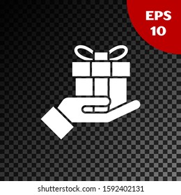White Gift box in hand icon isolated on transparent dark background. Merry Christmas and Happy New Year.  Vector Illustration