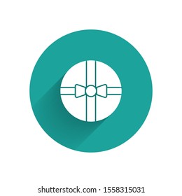White Gift box icon isolated with long shadow. Merry Christmas and Happy New Year. Green circle button. Vector Illustration