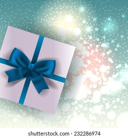 White gift with ribbon and bow top view. Christmas background