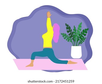 A white girl practices yoga in the Anjanasana position. The concept of a healthy lifestyle and sports.