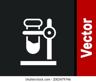White Glass test tube flask on stand icon isolated on black background. Laboratory equipment.  Vector