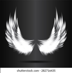 white glowing, stylized angel wings on a black background. vector