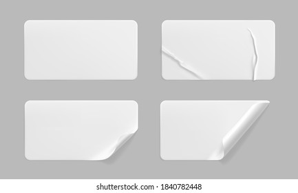 White glued crumpled stickers with curled corners mock up set. Blank white adhesive paper or plastic sticker label with wrinkled and creased effect. Template label tags close up. 3d realistic vector