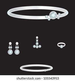 white gold set from necklace ring earrings brooch and bracelets with blue brilliants on black background