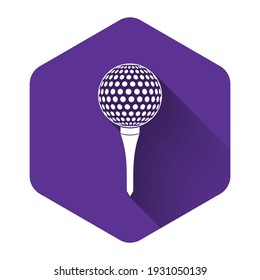 White Golf ball on tee icon isolated with long shadow. Purple hexagon button. Vector Illustration