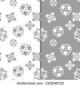 White and gray floral backgrounds. Set of seamless patterns for textile and wallpapers