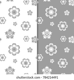 White and gray floral backgrounds. Set of seamless patterns for textile and wallpapers