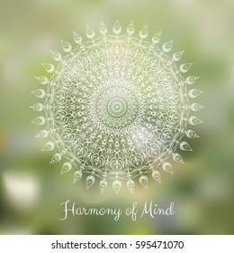 White hand drawn mandala design element on blurred spring grass background.  Yoga motivational poster. Beautiful floral background for resort and spa.  Indian decorative element. Inspiration quote