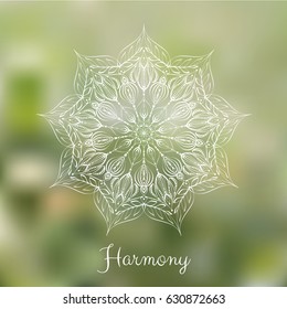 White hand drawn mandala design element on blurred background. 