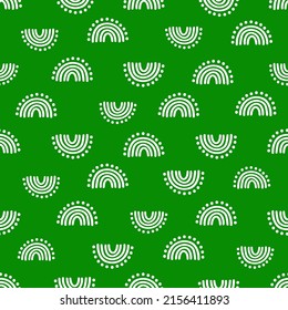 White hand drawn rainbow with dots seamless pattern with green background.