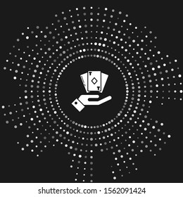 White Hand holding deck of playing cards icon isolated on grey background. Casino gambling. Abstract circle random dots. Vector Illustration