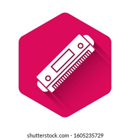 White Harmonica icon isolated with long shadow. Musical instrument. Pink hexagon button. Vector Illustration