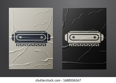 White Harmonica icon isolated on crumpled paper background. Musical instrument. Paper art style. Vector Illustration