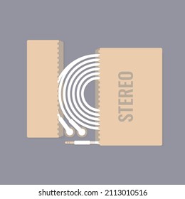 White headphones lying in a cardboard box with the inscription "Stereo".