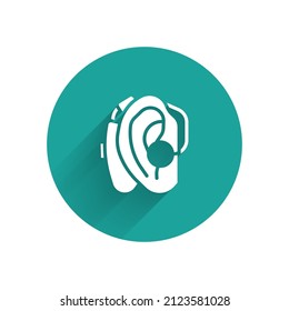 White Hearing aid icon isolated with long shadow. Hearing and ear. Green circle button. Vector