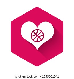 White Heart with basketball ball inside icon isolated with long shadow. Basketball love. Pink hexagon button. Vector Illustration