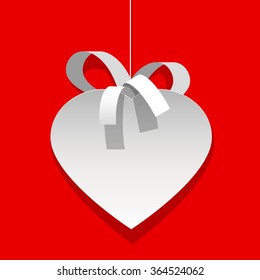 A white heart cut out of paper. with a Ribbon on a red. Background Greeting card. Element for design