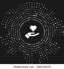 White Heart on hand icon isolated on grey background. Hand giving love symbol. Abstract circle random dots. Vector Illustration